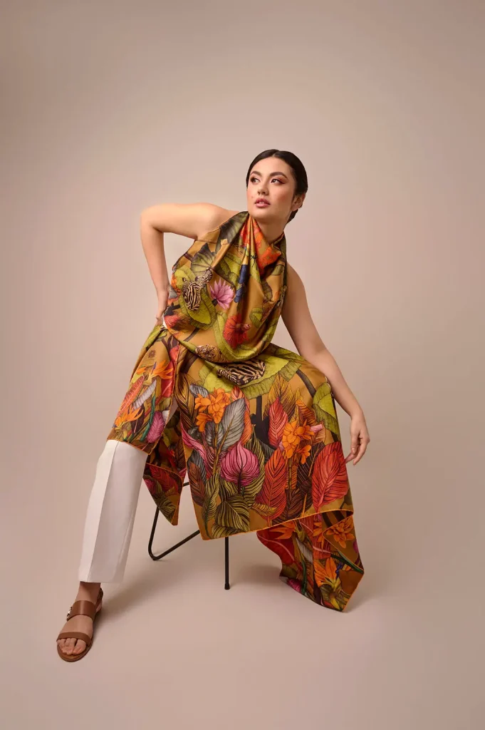Model wearing Ilona Tambor True Summer silk scarf with tropical animals and botanical motifs