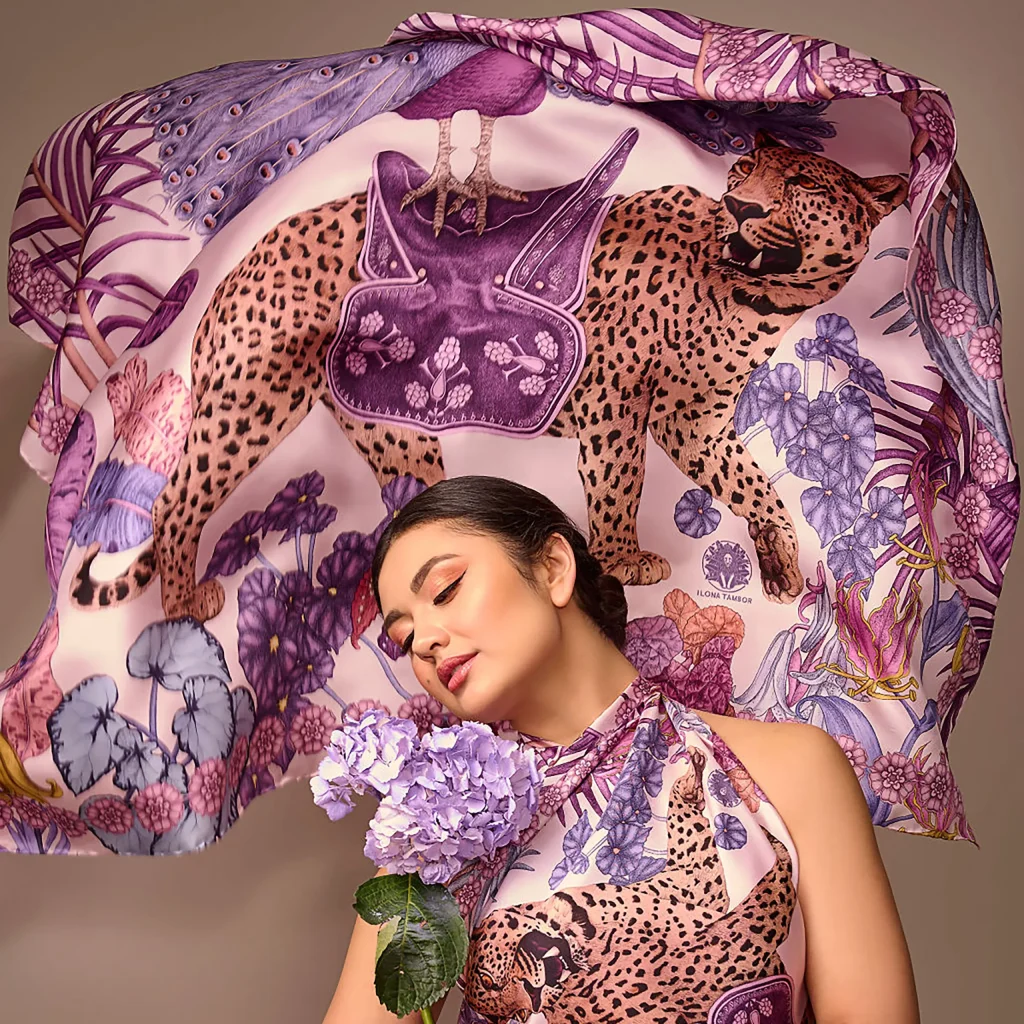 Model wearing Ilona Tambor silk scarf from Spring Summer 2024 collection featuring Jungle Dream illustration with leopard and botanical motifs