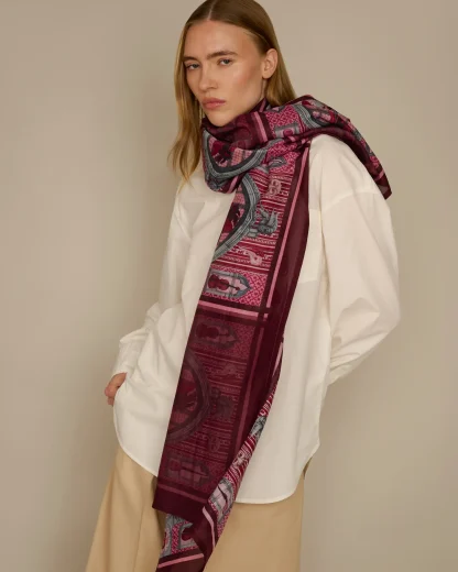 Woman wearing pink cotton silk scarf with Venetian carnival design by Ilona Tambor