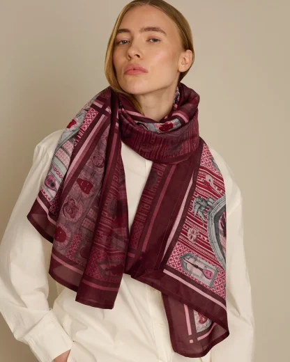 Woman wearing pink cotton silk scarf with Venetian carnival design by Ilona Tambor