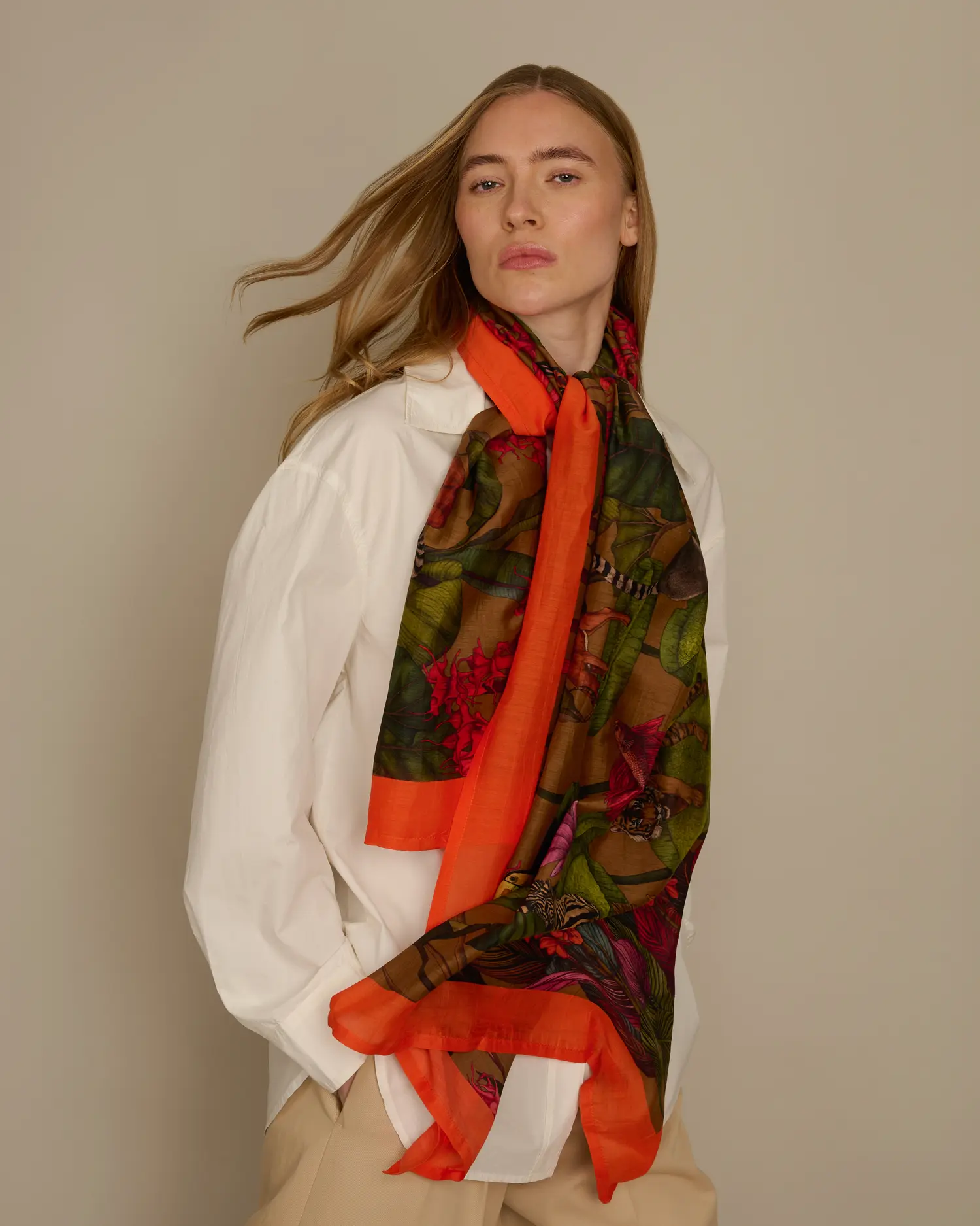 Woman wearing gold cotton silk scarf with tropical animal design by Ilona Tambor