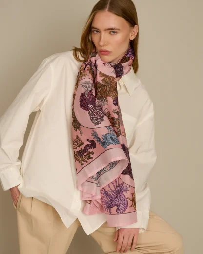 Woman wearing pink cotton silk scarf with sea life inspired design by Ilona Tambor